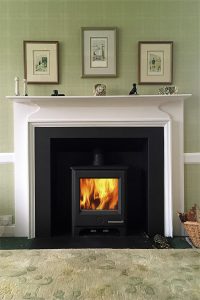 stove installed into a traditional fireplace using a convector box